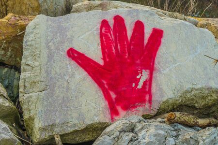 Red hand drawn on the big stoneの写真素材