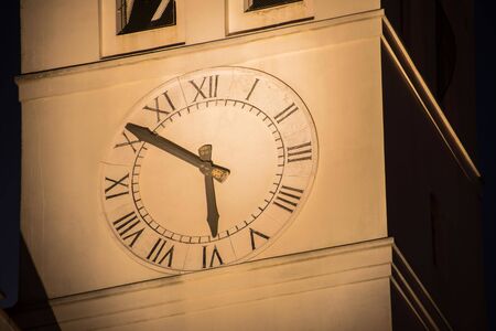 Ancient clock tower at night in the Italian cityの写真素材