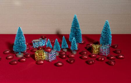 trees with fake Christmas packages on red floorの写真素材