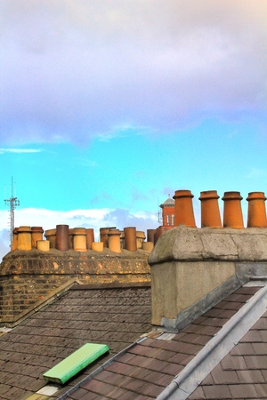 Chimneys and chimney pots on the roof of the housesの写真素材