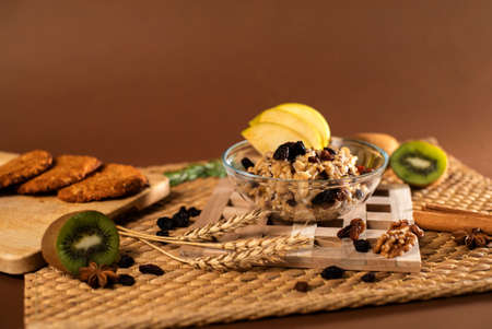 Breakfast with Oatmeal Porridge, Cookies, Nuts and Fruits. The Concept of a Healthy Lifestyleの写真素材