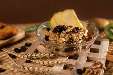 Oatmeal Porridge with Nuts, Fruits and Raisin. Closeup. Healthy Breakfast