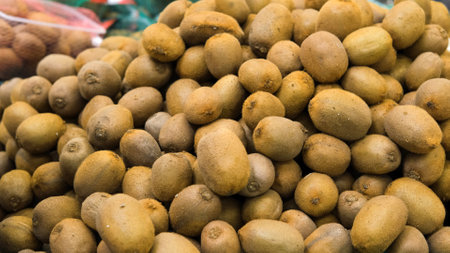 Close up of pile of kiwi at grocery store or market. Healthy organic food and lifestyle conceptの写真素材