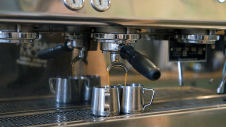 Espresso pouring from professional coffee machine, the process of preparing fresh aroma coffee drinkの写真素材