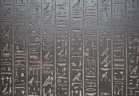 Ancient egiptian hyeroglyphs engraved in a black stoneの写真素材