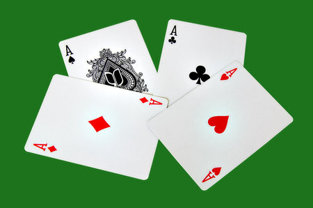 Four aces isolated in a green background with clipping pathのeditorial素材