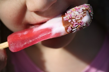 Close up of a girl eating ice creamの写真素材