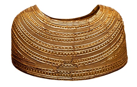 Ancient gold cape from Bronze Age Britain isolated on white 