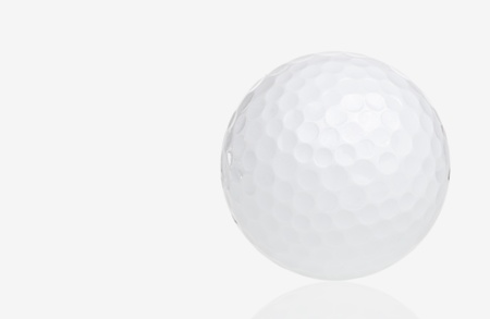 Golf ball with reflections on a white backgroundの写真素材