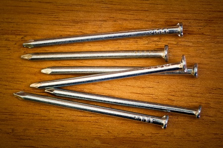 Nails on a wood backgroundの写真素材