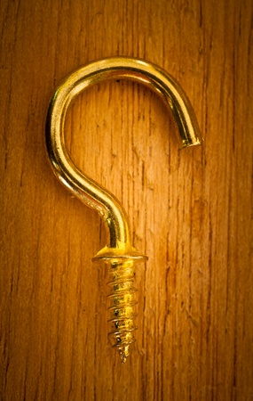 Golden eye bolt on a wood backgroundの写真素材