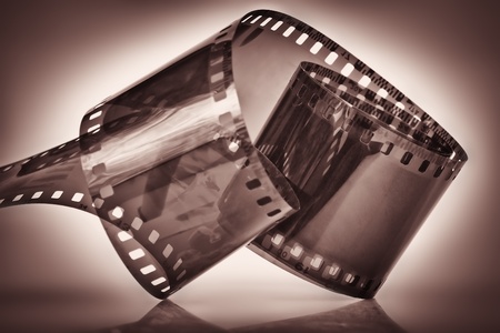 35 mm film on a dramatically illuminated dark depia backgroundの写真素材