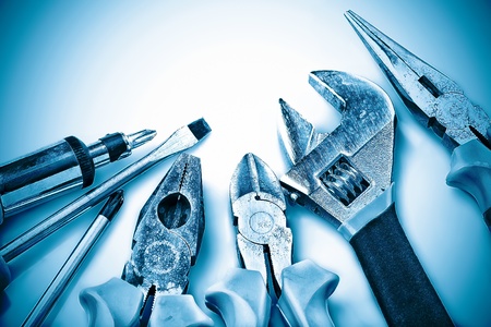 Set of manual tools on a blue background
