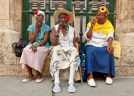 HAVANA-MAY 19:Old ladies with cigars May 19,2011 in Havana.Iconic characters like these are an attraction for the more than 2 million tourists who go to Cuba each year to enjoy its distinct cultureのeditorial素材
