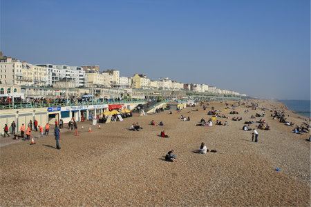 BRIGHTON,UK-March 31:Visitors enjoying the beach March 31,2011 in Brighton.The seafront is full of bars and restaurants and being less than an hour from London has made the city a popular destinationのeditorial素材