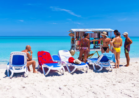 VARADERO,CUBA-JULY 16:Tourists buy souvenirs from a local seller July 16,2011 in Varadero.With over 1 million visitors a year,Varadero is the main destination for the growing cuban tourist industryのeditorial素材