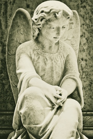 Old statue of a very sad angelの写真素材