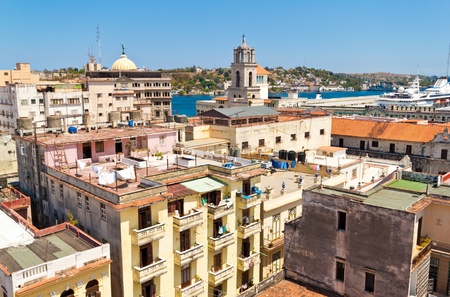 The roofs of Old Havana with a cruiser ship in the nearby bayの写真素材