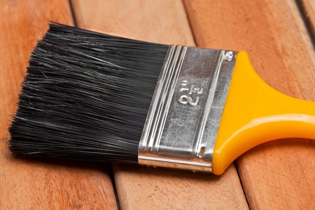 Paint brush over wooden boardsの写真素材