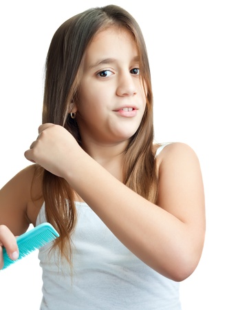Beautiful hispanic girl combing her hair isolated on a white backgroundの写真素材