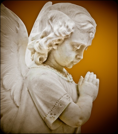 Child angel statue praying with a vintage lookの写真素材