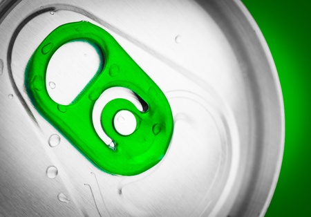 Macro shot of a beer or soft drink can on a green background