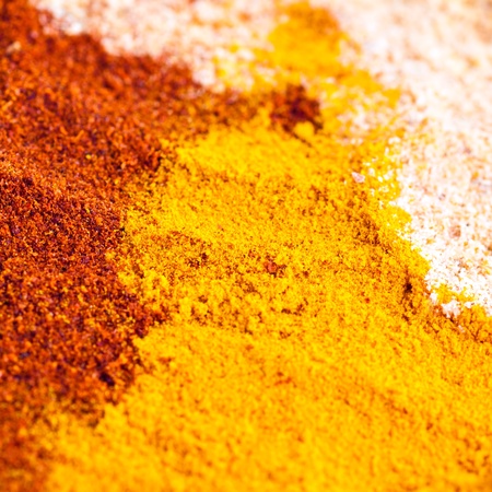Three different colorful finely powdered spices backgroundの写真素材