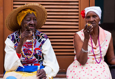 HAVANA-FEBRUARY 26 Women in typical clothing February 26,2012 in Havana With the growth of foreign tourism people like these,working for tips,make their living posing as traditional cuban charactersのeditorial素材