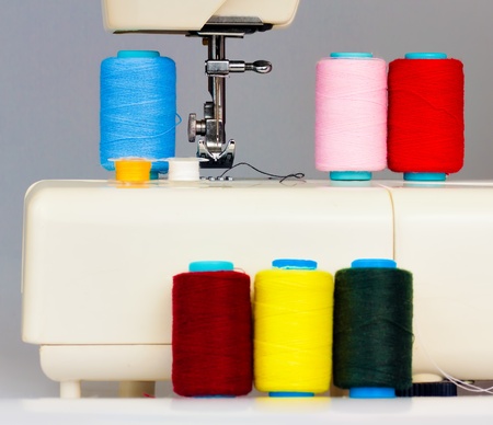 Sewing machine and a set of colorful reels with threadの写真素材