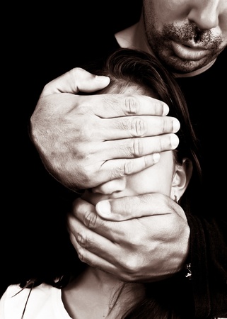 Child abuse and harassment by an unknown adult man who covers her eyes and mouthの写真素材