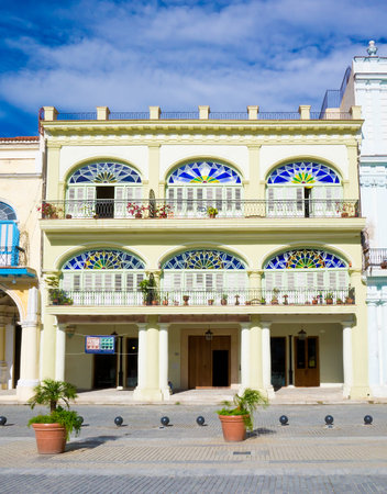 Colorful colonial building in Havana with  distinct traditional architecture elements such as porticoes,balconies and colorful stained glass windows and doorsのeditorial素材