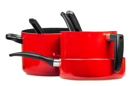 Set of metallic red cooking pots and pans isolated on whiteの写真素材