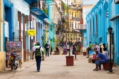 Street scene with cuban people and colorful old buildings in Havana Street scene with cuban people and colorful old buildings in Havana