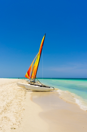Sailing boat on the white sands of Varadero beach in Cuba on a beautiful summer dayの写真素材