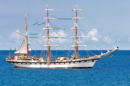 Sailing ship cruising on open waters over a a calm blue seaの写真素材