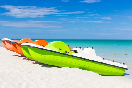 Colorful pedalos docked at the shore of the tropical beach of Varadero in Cubaの写真素材