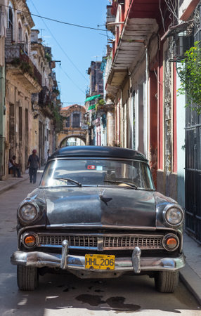 Old american car in a street sidelined with decaying buildings  in Havana These cars,still in use after many decades,have become a worldwide known symbol of Havanaのeditorial素材