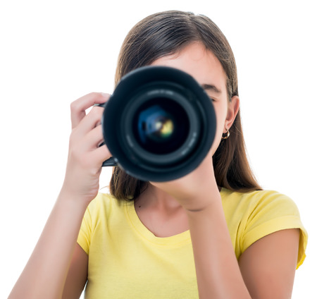 Hispanic girl taking a picture using a professional camera isolated on whiteの写真素材