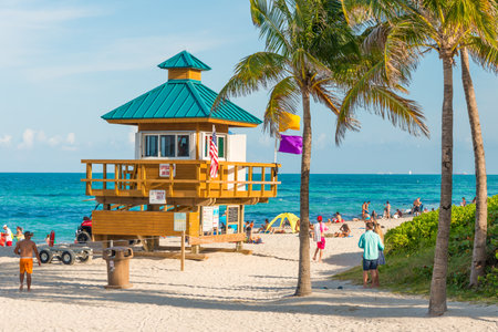 People enjoying the beach near an iconic lifeguard tower in South Beach on a beautiful summer dayのeditorial素材