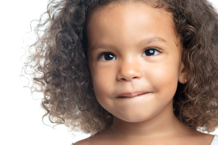 Close up portrait of a little girl with an afro hairstyleの写真素材