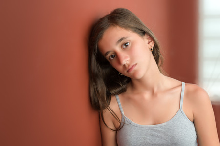 Beautiful hispanic teenage girl with a serious expressionの写真素材
