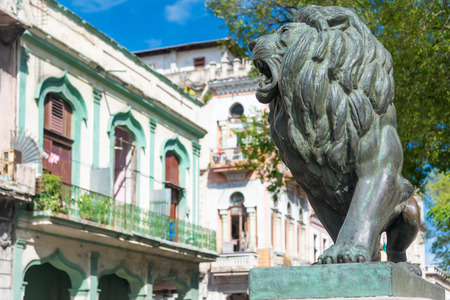 Bronze lion and historic buildings at El Prado Boulevard, a famous landmark in Havanaの写真素材