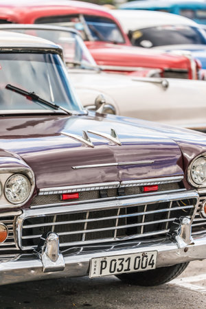 Vertical image of a group of vintage american cars in Havana