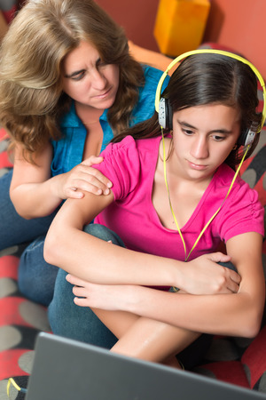 Teenage problems - Worried mother tries to comfort her sad teenage girlの写真素材