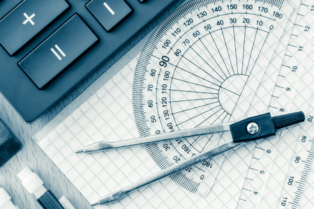 School supplies used in math , geometry or  science toned in blue
