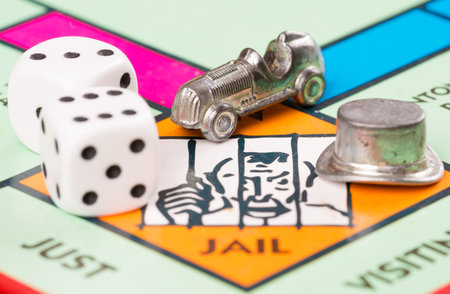 LONDON,UK - FEBRUARY 11, 2015 : Dice and car token next to the JAIL space in a Monopoly game boardのeditorial素材