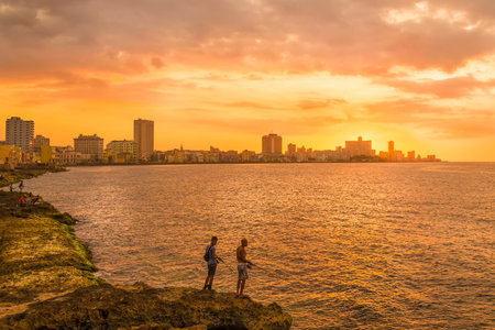 HAVANA,CUBA - MARCH 5, 2015 : Sunset in Havana with two unidentified fishermen on the foregroundのeditorial素材
