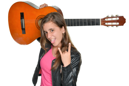 Trendy hispanic teenage girl carrying a guitar over her shoulders isolated on white