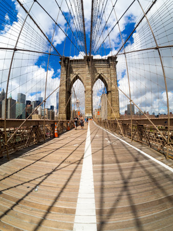 Tourists at the Brooklyn Bridge in New York on a beautiful summer dayのeditorial素材