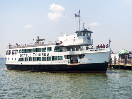 Statue cruises boat docked at Liberty Island in New York Cityの写真素材